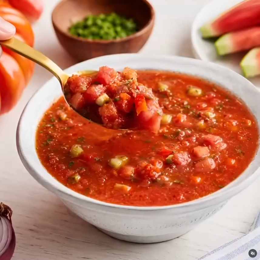 Chilled watermelon gazpacho recipe served in a ceramic bowl with fresh cucumber and basil garnish.