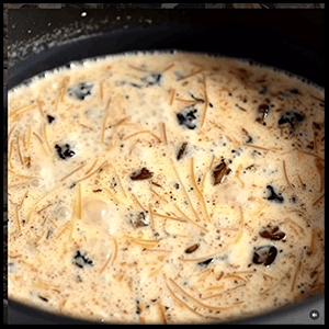 Creamy sweet vermicelli pudding served in a bowl and topped with chopped nuts