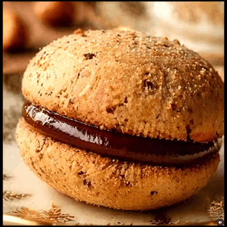 Platter of authentic Italian Baci di Dama hazelnut sandwich cookies filled with dark chocolate