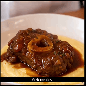 Slow-cooked Osso Buco featuring a tender, braised veal shank with rich gravy, served over a bed of creamy saffron risotto.