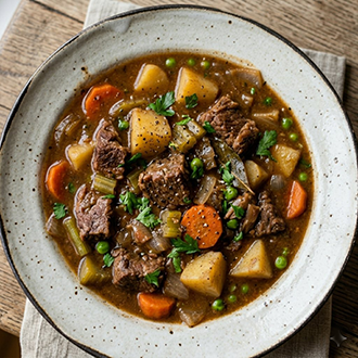 Turkish Inspired Lamb Stew with tender lamb, vegetables, and rich broth in a serving bowl.