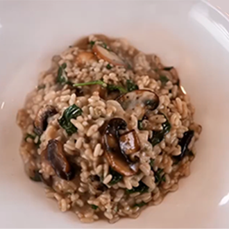 Creamy Italian mushroom risotto topped with shaved parmesan and fresh parsley